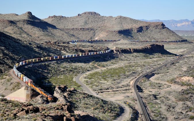From Julien’s collection, a BNSF train parallels a portion of Route 66 near Kingman, Arizona. 