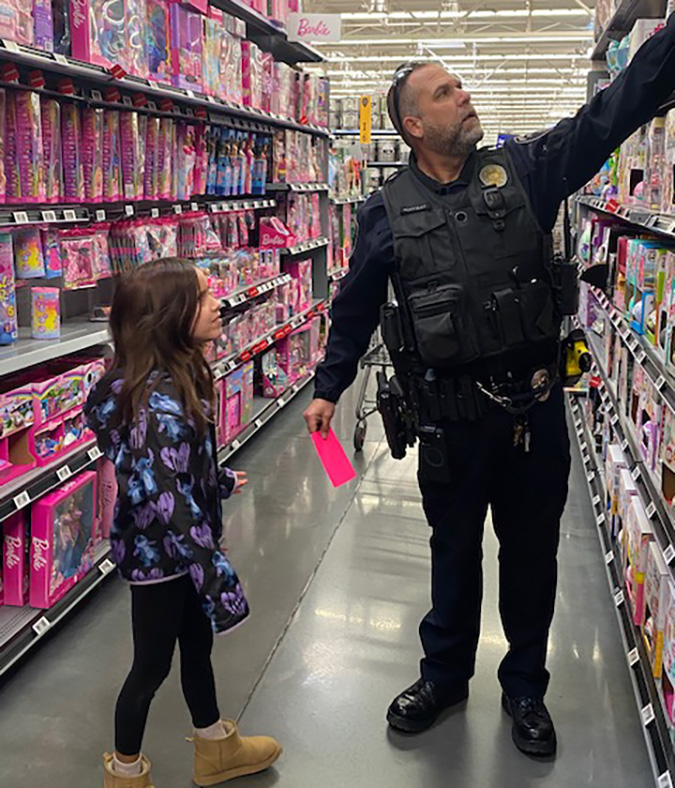 Rick Colbert helps a young shopper. Rick Colbert helps a young shopper.