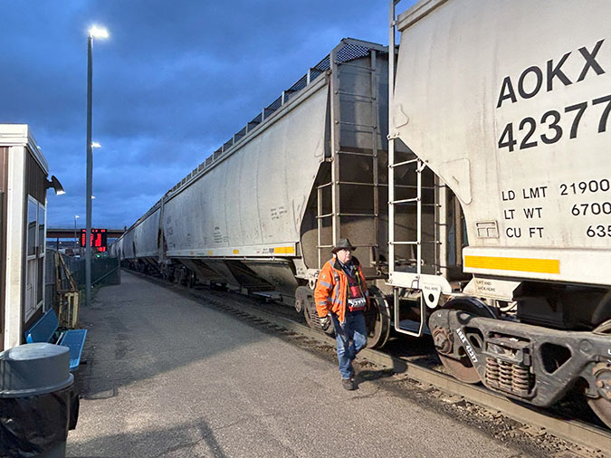 Switchman Lee Flandrich inspects covered hopper cars during the humping process at Northtown. 