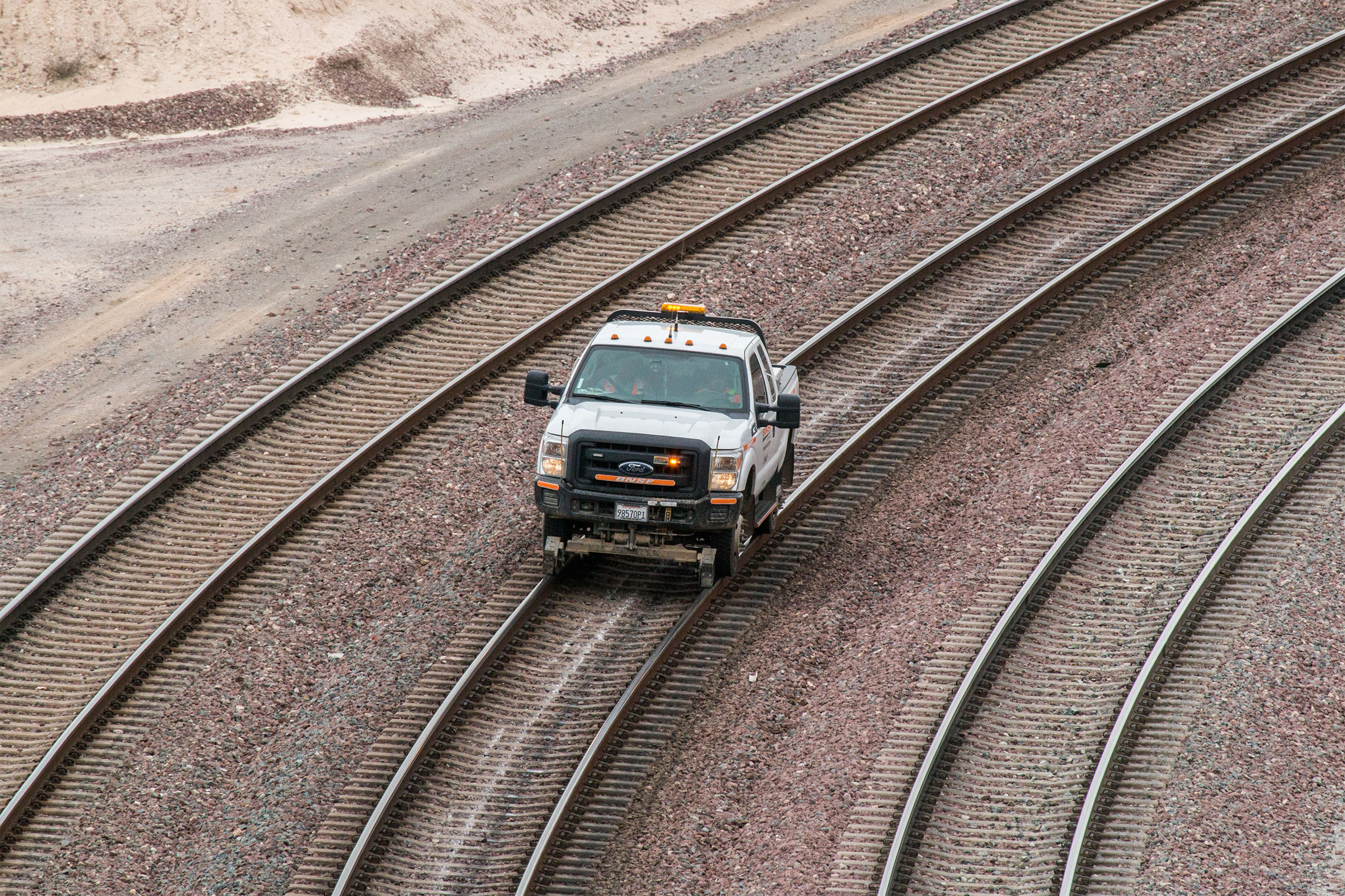 Hyrail vehicles can travel on both train tracks and roads. 