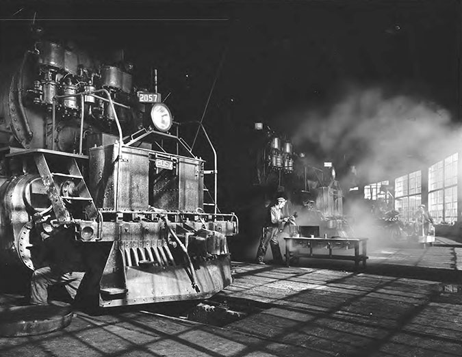 Great Northern employees repairing locomotives at the Whitefish roundhouse Great Northern employees repairing locomotives at the Whitefish roundhouse
