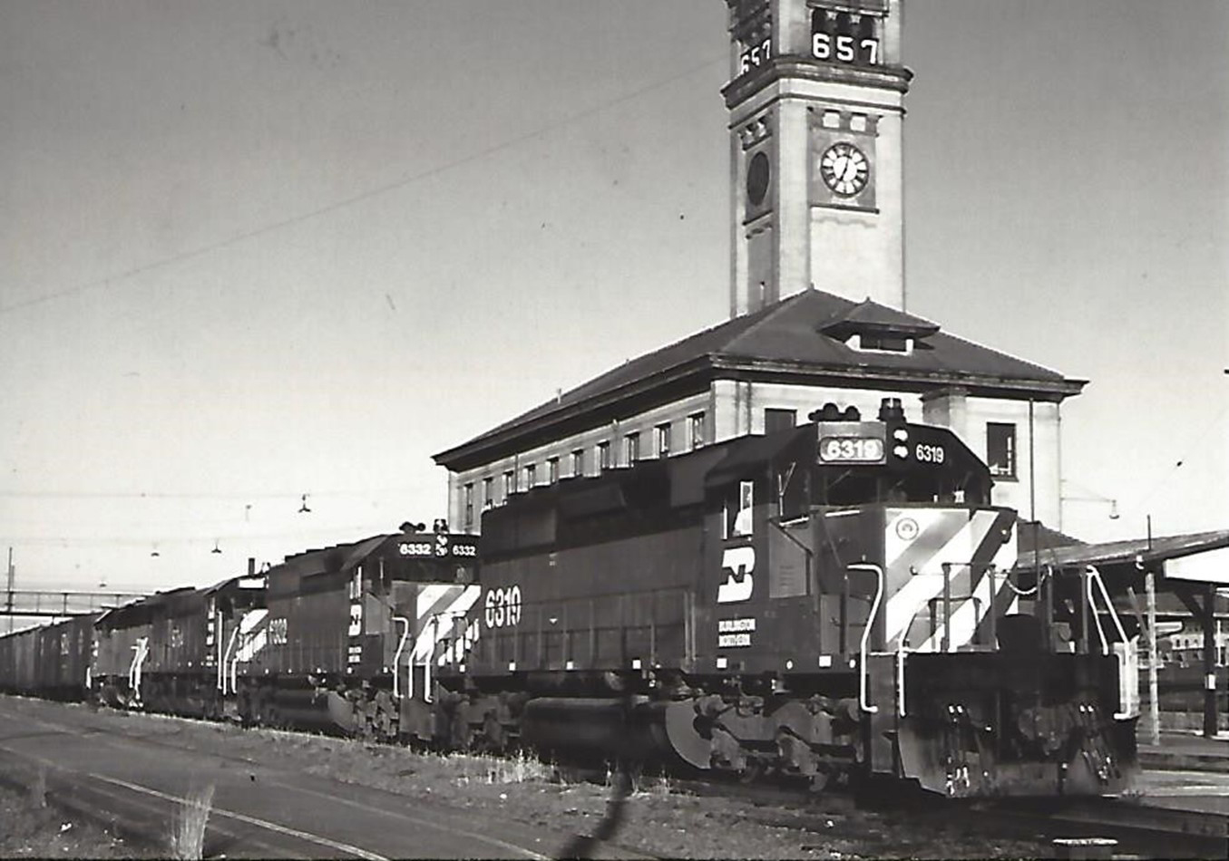  A Burlington Northern train at the Great Northern depot and clock tower, circa 1972. The “657” on the clock tower is a countdown clock, indicating 657 days until the start of the World’s Fair/Expo.